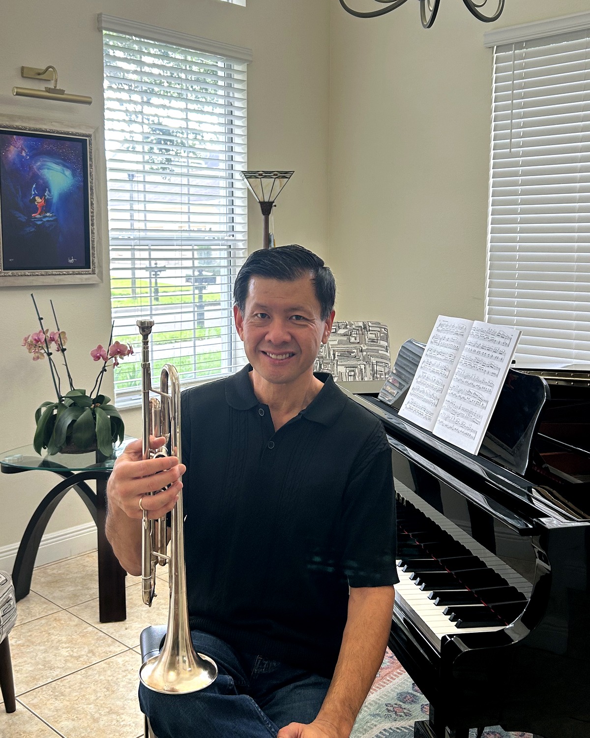 Seiji Sage Shiraishi seated with a trumpet beside a piano